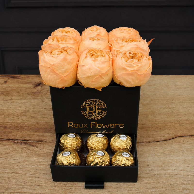 Peonías naturales preservadas en color durazno pastel con cajón de chocolates Ferrero Rocher de regalo